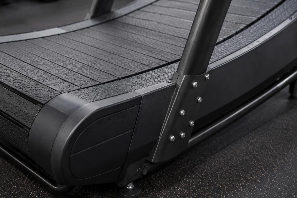 Close up of curved treadmill running surface and frame construction