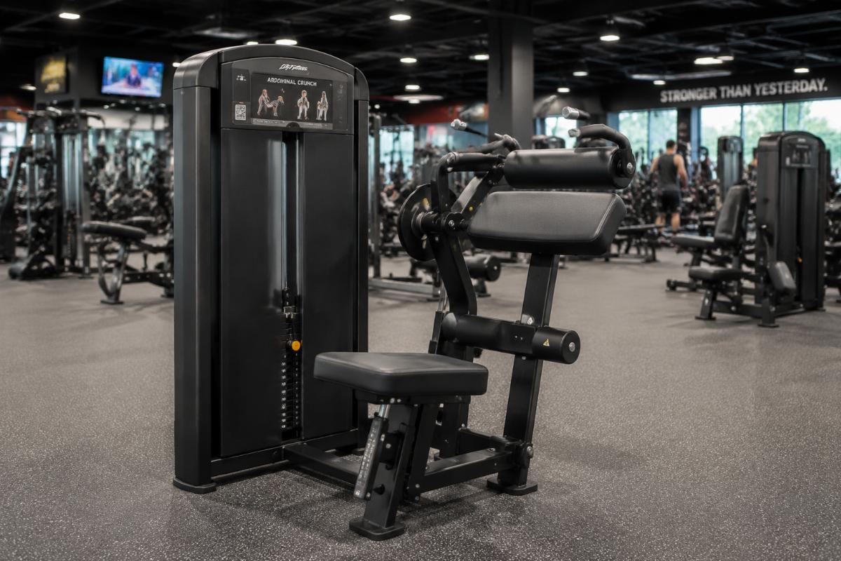 Selectorized abdominal crunch machine in a high-traffic commercial gym floor